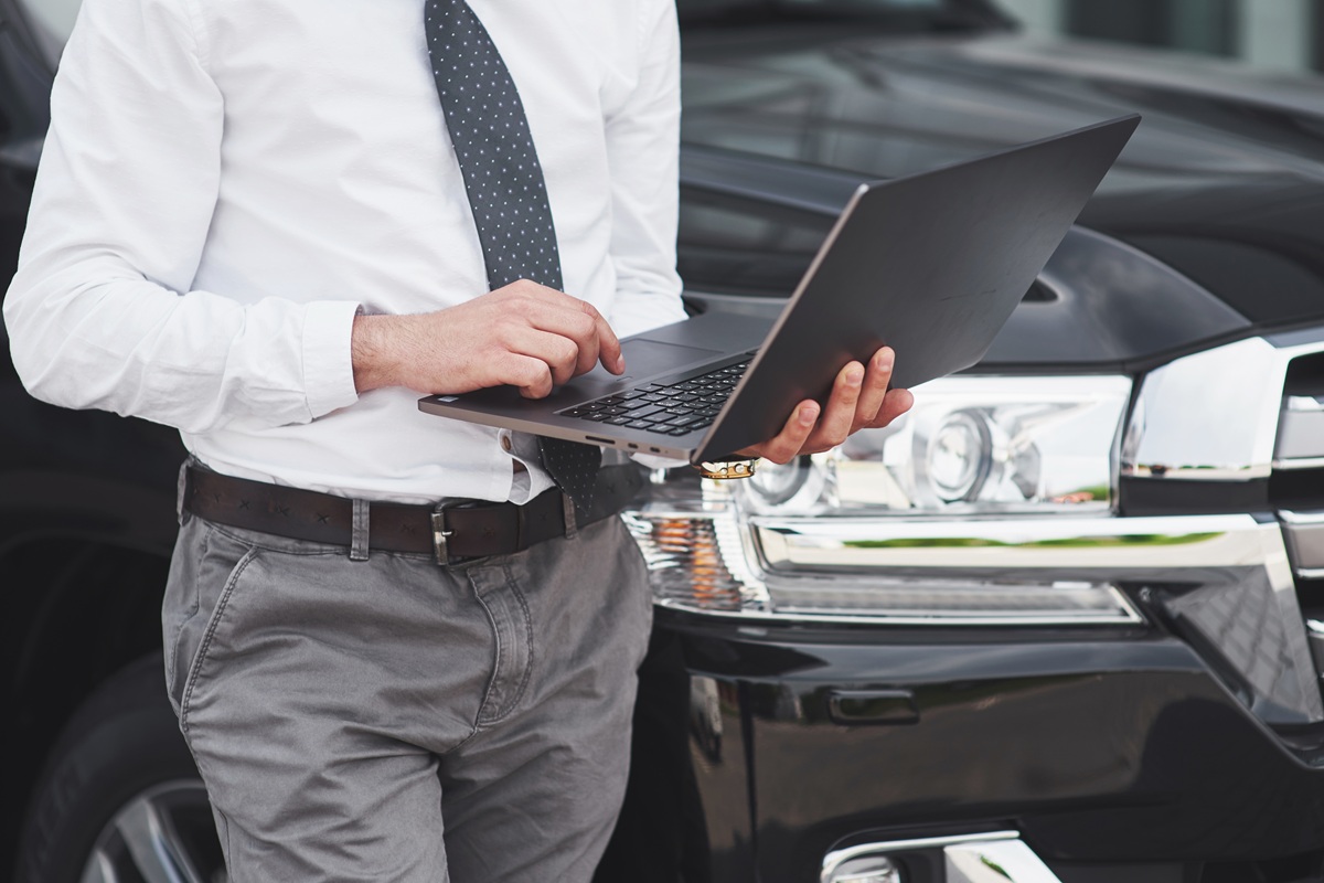 Man is man working laptop getting ideas on how to start a limo business