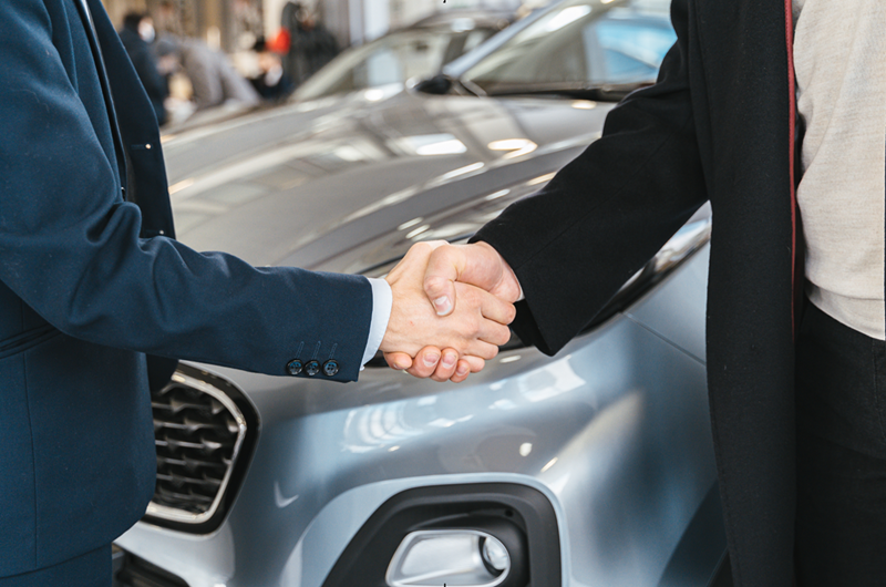 Business Partners Shaking Hands with Limo Car in the Side